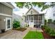 Charming backyard with screened porch, staircase, patio, lush greenery and outdoor grill, great for entertaining at 1629 Ware Bottom Ln, Mount Pleasant, SC 29464
