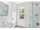 Bright, all-white bathroom with glass shower, window and classic fixtures for a clean, fresh feel at 1629 Ware Bottom Ln, Mount Pleasant, SC 29464