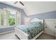 Bedroom with white walls, a floral bedspread, and windows with white shutters at 1629 Ware Bottom Ln, Mount Pleasant, SC 29464
