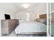 Bright bedroom with a desk, small refrigerator, and double doors at 1629 Ware Bottom Ln, Mount Pleasant, SC 29464