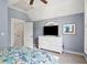 Bedroom with blue walls, a ceiling fan, a television, and a sunny window at 1629 Ware Bottom Ln, Mount Pleasant, SC 29464