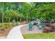 Community area with seating and a sidewalk, inviting residents to relax and socialize amidst trees at 1629 Ware Bottom Ln, Mount Pleasant, SC 29464