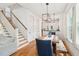 Bright dining area featuring hardwood floors, a modern light fixture, and easy access to the staircase and kitchen at 1629 Ware Bottom Ln, Mount Pleasant, SC 29464