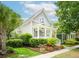 Charming two-story home with a welcoming front porch, manicured landscaping, and American flag at 1629 Ware Bottom Ln, Mount Pleasant, SC 29464