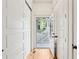 Hallway with white wooden siding, wooden floor and glass door open to a porch at 1629 Ware Bottom Ln, Mount Pleasant, SC 29464
