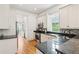 Bright kitchen with granite countertops, stainless appliances, hardwood floors, and natural light from a window at 1629 Ware Bottom Ln, Mount Pleasant, SC 29464