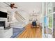 Bright open-concept living room with hardwood floors, fireplace, and staircase, seamlessly connected to the dining area at 1629 Ware Bottom Ln, Mount Pleasant, SC 29464