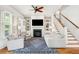 Cozy living room with a fireplace, built-in shelves, and a comfortable seating area, illuminated by natural light at 1629 Ware Bottom Ln, Mount Pleasant, SC 29464