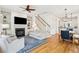 Open concept living room with hardwood floors, fireplace, and seamless flow to the dining and kitchen areas at 1629 Ware Bottom Ln, Mount Pleasant, SC 29464