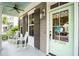 Charming front porch with rocking chairs and a light green front door, creating a cozy entrance at 1629 Ware Bottom Ln, Mount Pleasant, SC 29464