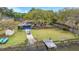 Aerial view of a waterfront property featuring boat lift, fenced yard, and mature trees at 1673 Mcclain St, Charleston, SC 29407
