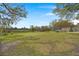Large backyard with mature trees and open green space, offering plenty of room for recreation and relaxation at 1673 Mcclain St, Charleston, SC 29407
