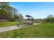 Backyard view with boat and trailer on concrete path leading to waterfront at 1673 Mcclain St, Charleston, SC 29407