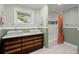 Modern bathroom boasts double sinks, custom vanity, and shower with decorative tile at 1673 Mcclain St, Charleston, SC 29407