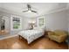 Bright bedroom features hardwood floors, neutral walls, and a cozy chair at 1673 Mcclain St, Charleston, SC 29407