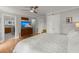 Bedroom showcasing hardwood floors, TV, ensuite bathroom, neutral color palette, and ceiling fan at 1673 Mcclain St, Charleston, SC 29407