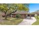 Beautifully landscaped brick home with covered parking and a long driveway at 1673 Mcclain St, Charleston, SC 29407