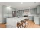 Bright kitchen with a large island, stainless steel appliances, custom cabinets, and quartz countertops at 1673 Mcclain St, Charleston, SC 29407