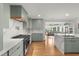 Kitchen features stainless steel appliances, custom cabinets, quartz countertops, and hardwood floors at 1673 Mcclain St, Charleston, SC 29407