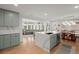 Open concept kitchen with island, stainless steel appliances, custom cabinets, hardwood floors, and eating area at 1673 Mcclain St, Charleston, SC 29407