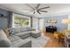 Bright living room with hardwood floors, large windows, and comfortable furniture at 1673 Mcclain St, Charleston, SC 29407