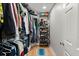Walk-in closet showcasing built-in shelving, wood floor and a door to the right at 1673 Mcclain St, Charleston, SC 29407