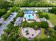 Aerial view of a community pool area with a playground, parking, and a pond at 1678 William Hapton Way, Mount Pleasant, SC 29466