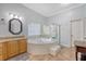 Bright bathroom featuring a soaking tub, separate shower, and granite countertops at 1678 William Hapton Way, Mount Pleasant, SC 29466