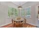 Cozy breakfast nook with natural lighting, wooden table and chairs, and decorative hanging light fixture at 1678 William Hapton Way, Mount Pleasant, SC 29466