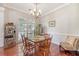 Charming dining room with a wooden table set, a decorative chandelier, and a bright window view at 1678 William Hapton Way, Mount Pleasant, SC 29466