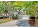 Charming single-Gathering home featuring a well-manicured lawn, shade trees, attached garage, and inviting curb appeal at 1678 William Hapton Way, Mount Pleasant, SC 29466