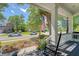 Charming front porch with rocking chairs and an American flag in a friendly neighborhood at 1678 William Hapton Way, Mount Pleasant, SC 29466