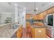 Spacious kitchen with granite countertops, stainless steel appliances, wood cabinets, and eat-in breakfast bar at 1678 William Hapton Way, Mount Pleasant, SC 29466