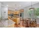 Well-lit kitchen featuring stainless appliances, wood cabinets, a central island, and a cozy breakfast nook at 1678 William Hapton Way, Mount Pleasant, SC 29466