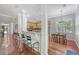Open-concept layout with a kitchen featuring granite countertops, wooden cabinets, and a breakfast bar at 1678 William Hapton Way, Mount Pleasant, SC 29466