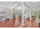 Open-concept living and dining area with hardwood floors and abundant natural light at 1678 William Hapton Way, Mount Pleasant, SC 29466