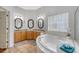 Well-appointed bathroom with a soaking tub, double vanities, and a window that provides natural light at 1678 William Hapton Way, Mount Pleasant, SC 29466