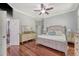 Bright main bedroom with stylish decor, hardwood flooring, and access to the ensuite bathroom and walk-in closet at 1678 William Hapton Way, Mount Pleasant, SC 29466