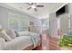 Airy main bedroom with hardwood floors, lots of natural light, and an ensuite bathroom at 1678 William Hapton Way, Mount Pleasant, SC 29466