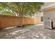Backyard featuring a wood fence, mature tree, and a concrete patio, perfect for outdoor living and entertaining at 1825 Brittlebush Ln, Johns Island, SC 29455