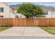 Property features a wooden fence, green tree, and a long driveway leading up to the home, providing privacy at 1825 Brittlebush Ln, Johns Island, SC 29455