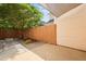 Backyard with a wooden fence, large tree, and stone patio, providing a private and inviting outdoor space at 1825 Brittlebush Ln, Johns Island, SC 29455