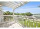 Enjoy an open-air view from the balcony, with well-kept landscaping and trees surrounding the property at 1825 Brittlebush Ln, Johns Island, SC 29455