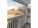 Balcony with white railing overlooking the water, street and palm trees at 1825 Brittlebush Ln, Johns Island, SC 29455