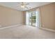 Bedroom with carpet, neutral paint, white trim and sliding glass doors to balcony at 1825 Brittlebush Ln, Johns Island, SC 29455