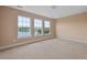 Bright bedroom with three large windows offering stunning water views, creating a serene living space at 1825 Brittlebush Ln, Johns Island, SC 29455