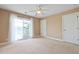 Neutral carpeted bedroom with neutral paint and a view to balcony with water view at 1825 Brittlebush Ln, Johns Island, SC 29455