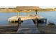 Picturesque lakefront dock with a covered seating area, offering serene water views and a relaxing outdoor space at 1825 Brittlebush Ln, Johns Island, SC 29455