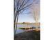 Charming lakefront dock with a covered gazebo and relaxing chairs, providing a serene escape with scenic water views at 1825 Brittlebush Ln, Johns Island, SC 29455