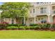 Charming two-story home with a pergola, lush greenery, and vibrant pink roses in the landscaped yard at 1825 Brittlebush Ln, Johns Island, SC 29455